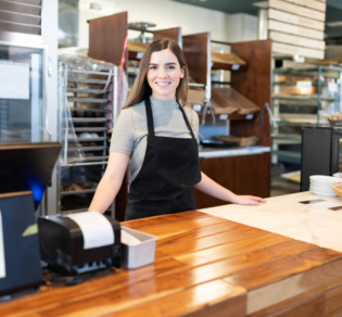 woman standing behind counter
